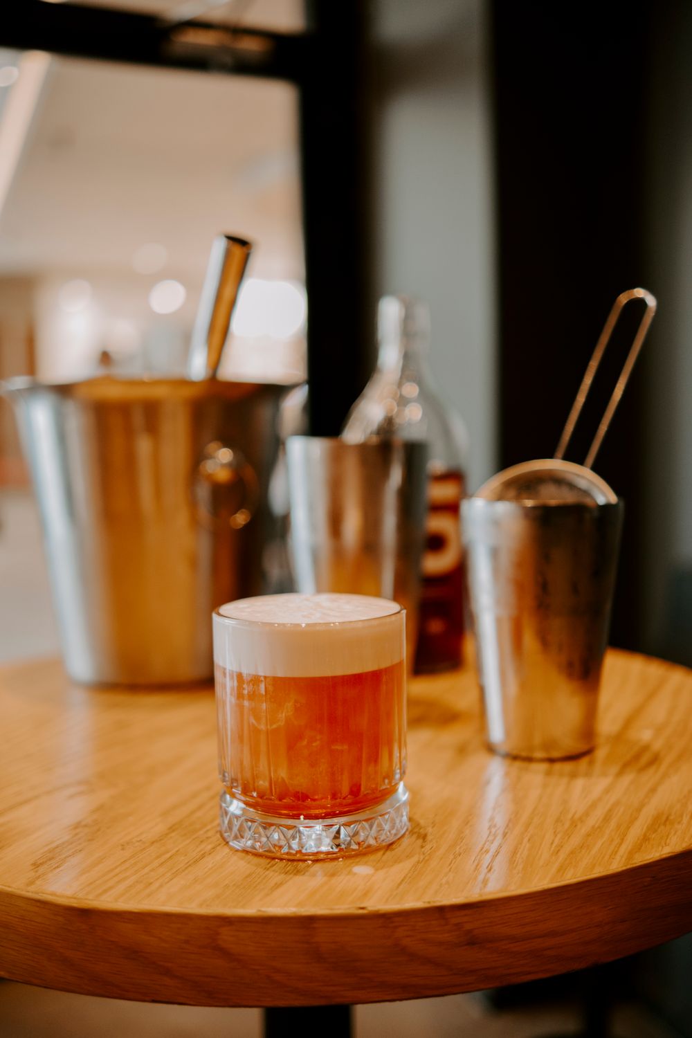 Non-alcoholic amaretto sour with a foam cap, served over ice in a rocks glass